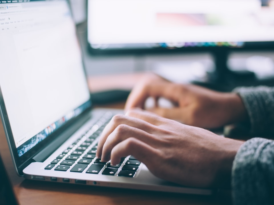 A person typing on a laptop