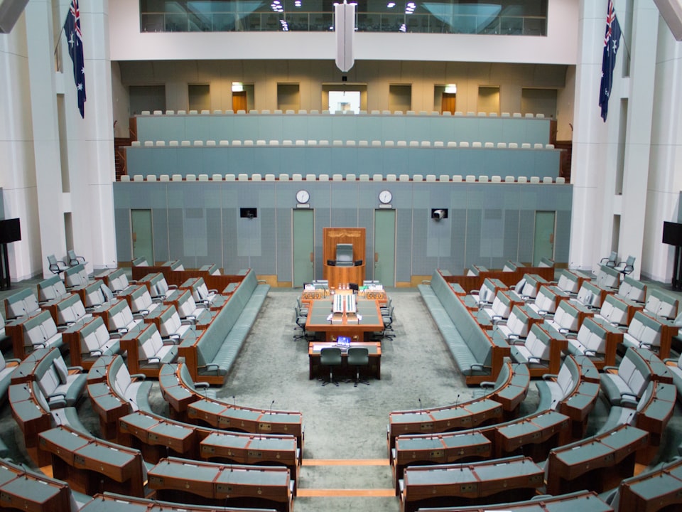 Rows of seats and a podium in a legislative chamber